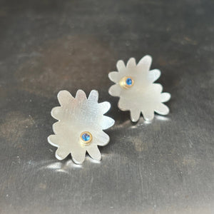 abstract flower shaped sterling silver stud earrings with blue stone set in gold