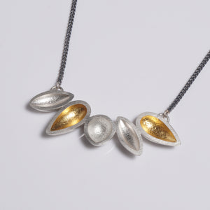 sterling silver necklace with 24k gold keum boo, hanging from an oxidised chain